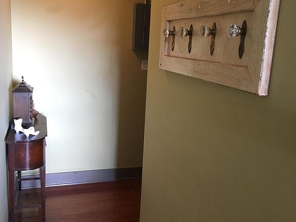 Front hallway, with antique doorknob coat rack