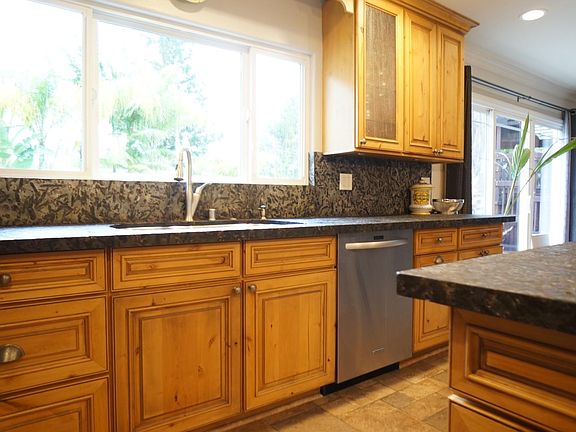 Solid hardwood cabinets w/granite/quartzite counters, recess