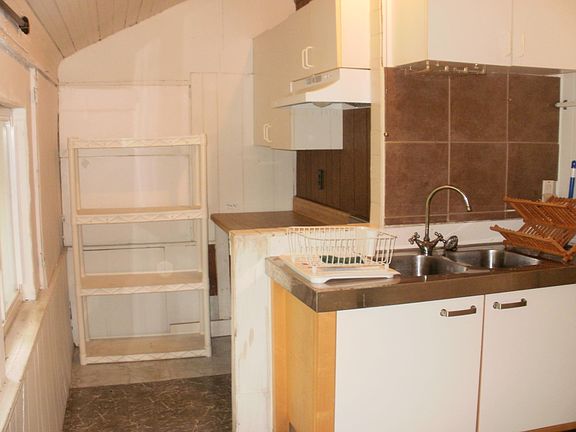 Kitchen has lots of storage space and counter to eat on.