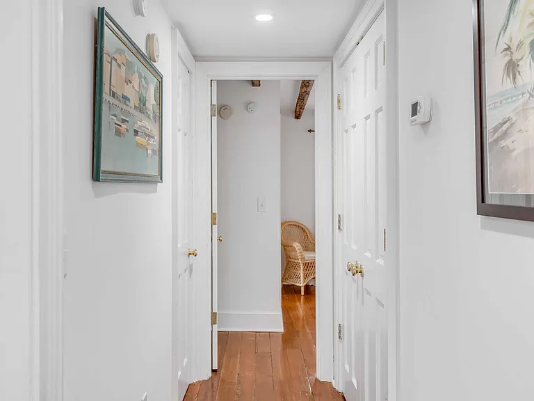 Hall to guest bedroom ( laundry station doors closed).