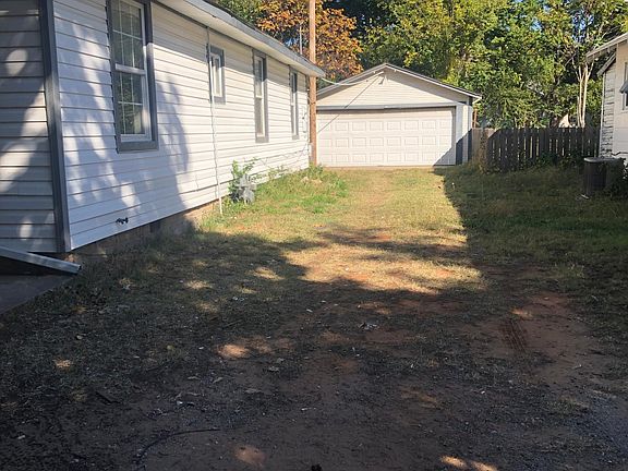 Two car detached garage has workshop connected to back.