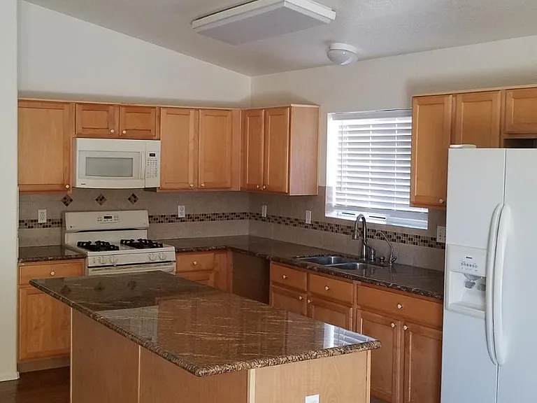 kitchen with island (these cabinets have been resurfaced)
