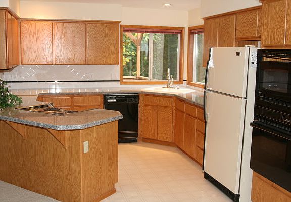 Kitchen has oak cabinets and granite counter tops.