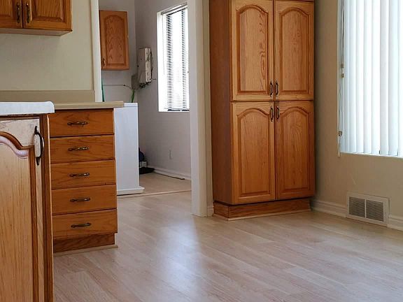 Kitchen and laundry room through doorway.