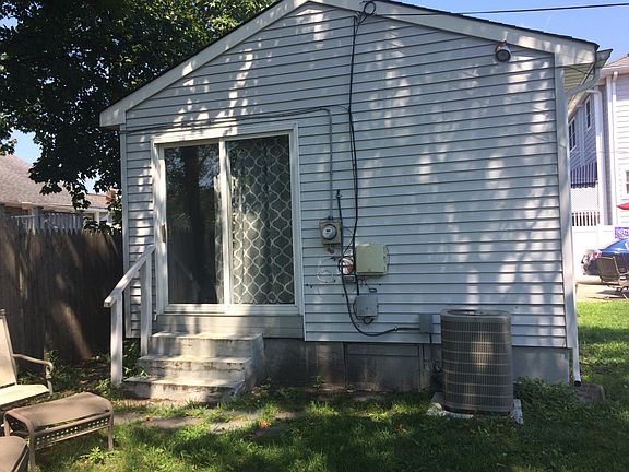 Sliders off Vaulted Great Room lead to side yard with lots of refreshing shade.