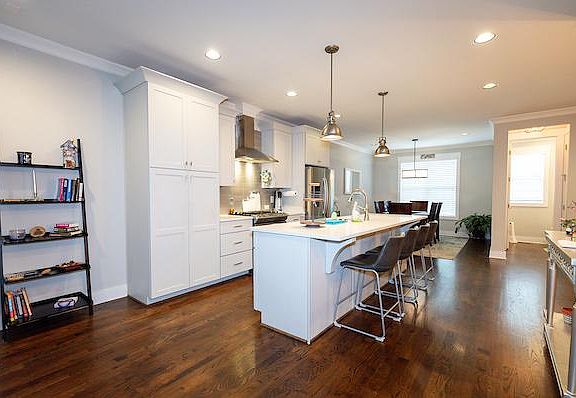 Professional chef's kitchen with 10 ft island and comfortable stools