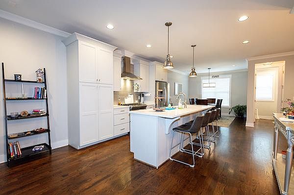 Professional chef's kitchen with 10 ft island and comfortable stools