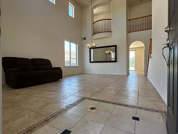 Entry to vaulted ceiling and open family area and dining room.