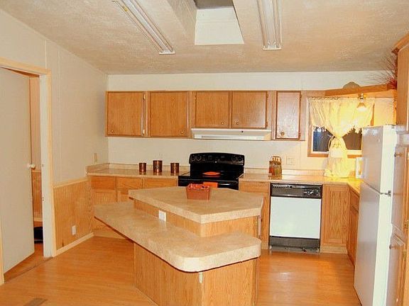wonderful kitchen with island, eating bar, new range and skylight.