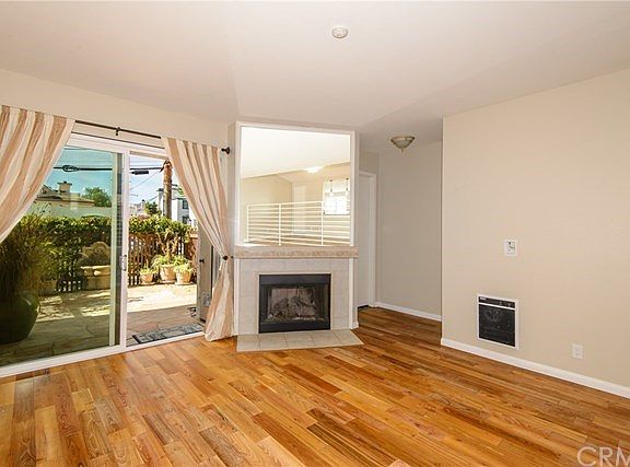 Living room with Teak wood flooring looking out to the private patio!