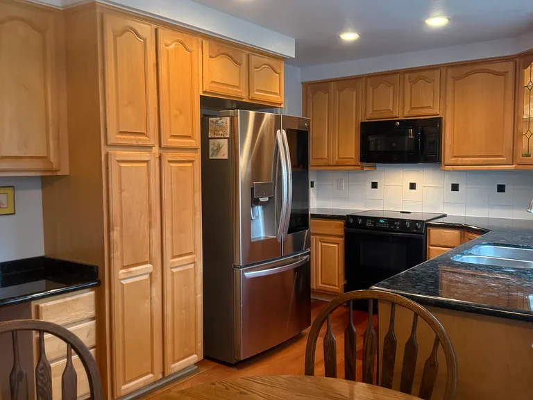 Completely Remodeled Kitchen Stunning unique granite, Jenn Air convection oven, GE convection microwave, S-steel frig, dishwasher, disposal, maple cabinets with pantry, roll out shelves and lazy Susan, small desk and multiple light sources.