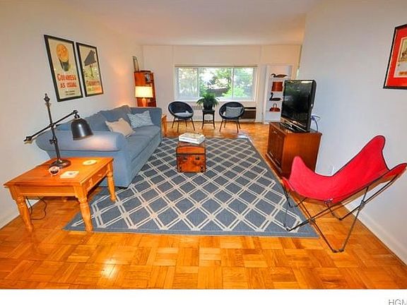 Living room opens to the "L" shaped dining room and has refinished parquet floors.  The room is 23'-4" x 12'-0" plus a entrance foyer.