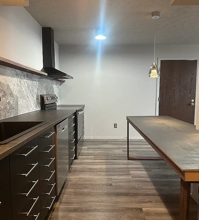Long galley kitchen with ample storage + seating.