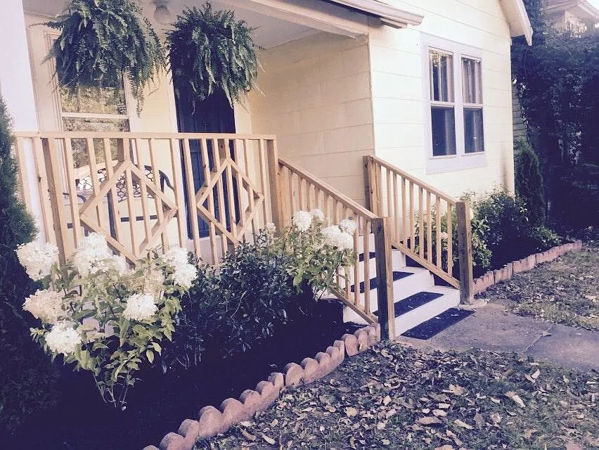 Enjoy the covered front porch and fenced front yard - 2215 Lindell Ave