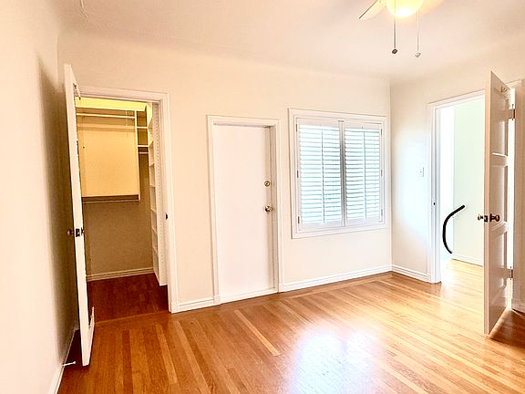 Bedroom closet and window with shutters