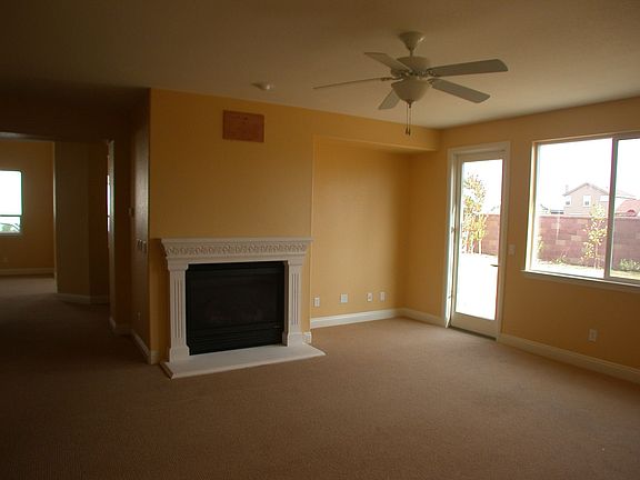 Open family room with fireplace leads to the yard.