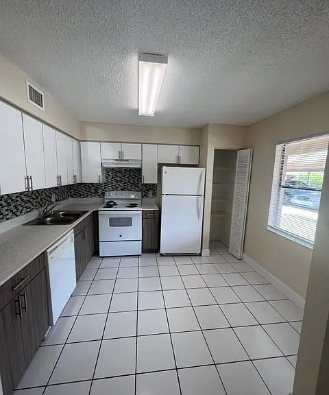 Kitchen with Quartz Countertops and Tiled Flooring