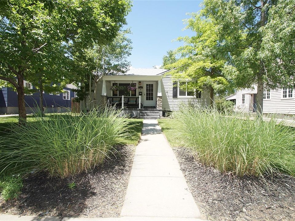 Gorgeous curb appeal with mature trees and a cozy covered porch.
