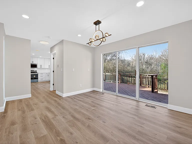 Dining area with light wood-type flooring, recessed lighting, chandelier, and patio doors
