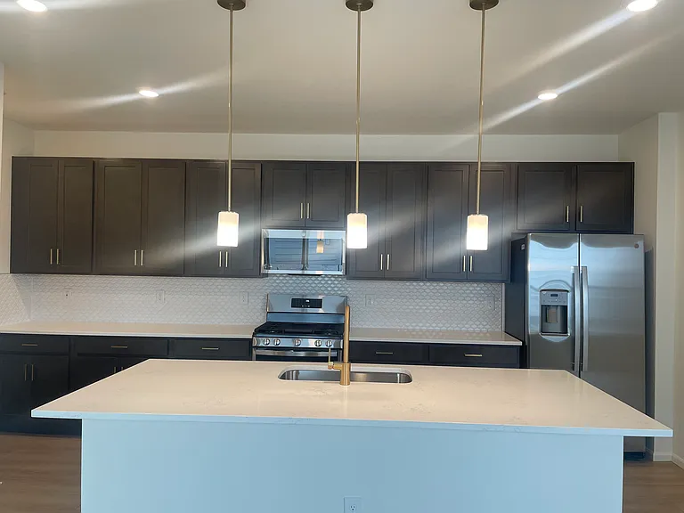 Kitchen with Quartz and Plenty of cabinets