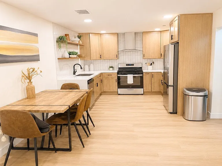 Open kitchen with ample cabinet storage, stainless appliances, and a dedicated dining area for everyday meals.