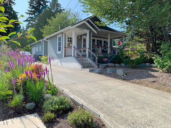 Long front driveway. Enter by the front door or the back door. Shaded front porch on East side of house. Sit out and watch the neighborhood. Low maintenance professionally landscaped yard.