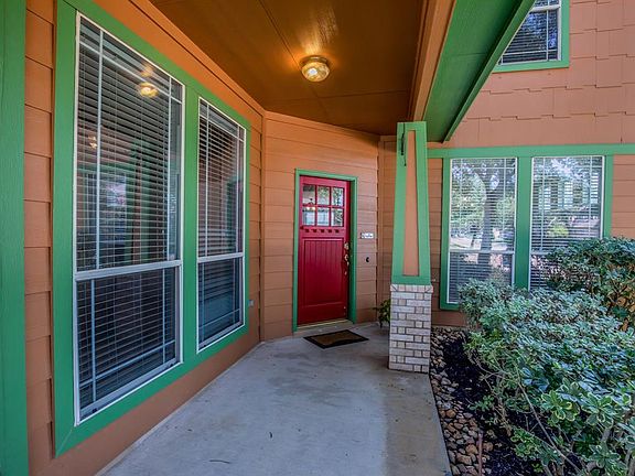Front porch overlooks the cul-de-sac and 3 spectacular oak trees. Porch turns to the left for additional rocking chair space and views.