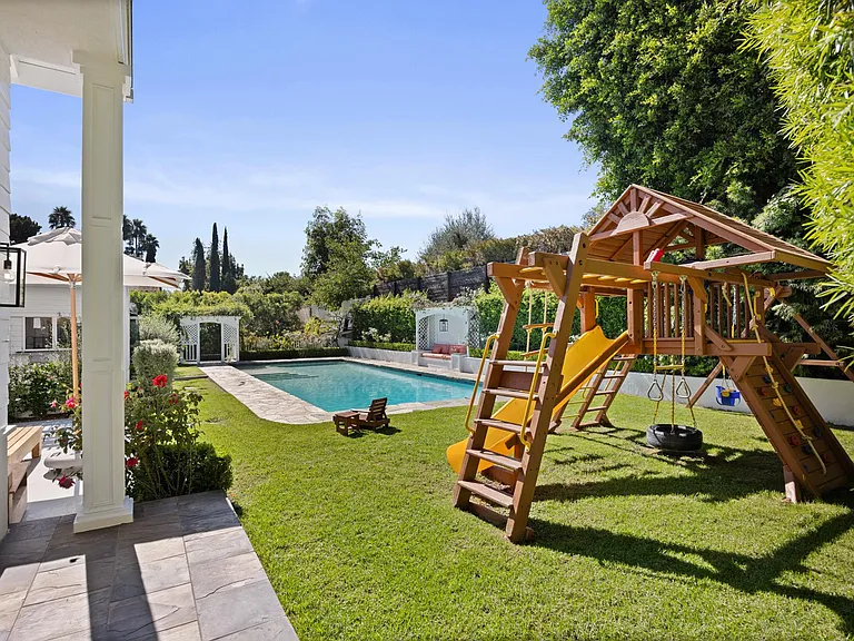 Explore outdoor fun at the backyard jungle gym _ slide and swings for family joy.