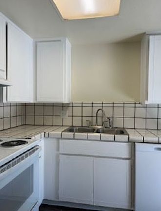 Kitchen features all new appliances, new paint, dual stainless steel sink with pot-style faucet, and new island with additional electrical outlets and overhead lighting!