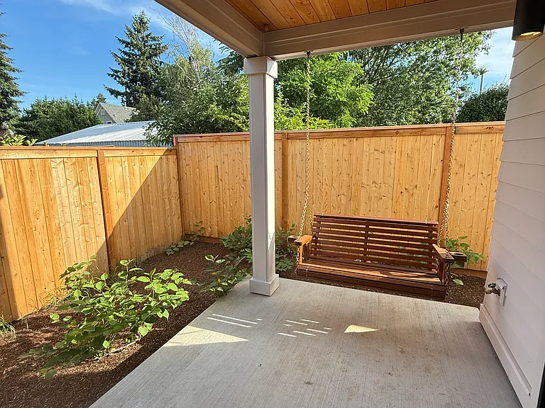 Backyard w/ porch swing.