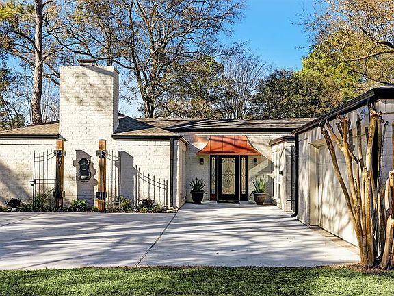 New Roof and Gutters; FRESHLY PAINTED in Striking Color Scheme - Brick in Rich Creamy Off White Brick against Black Trim. Note the Wrought Iron Gates that Enter the Back Yard, Breezeway; and the homes Feature Statement ! At the top of the Driveway, t