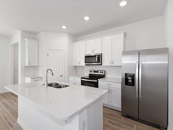 Kitchen in the Austen floorplan at 4625 Cross Prairie Parkway in The Meadow at Crossprairie