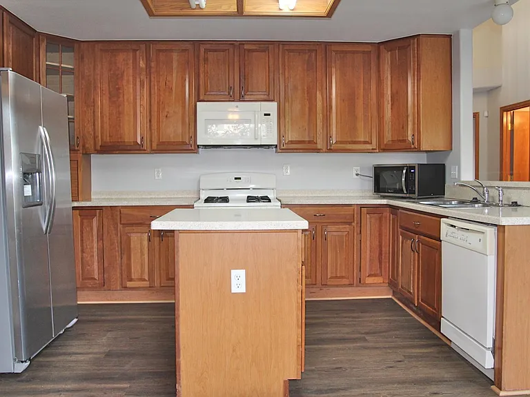 Kitchen offers good storage and measures 8'4 by 11'10"