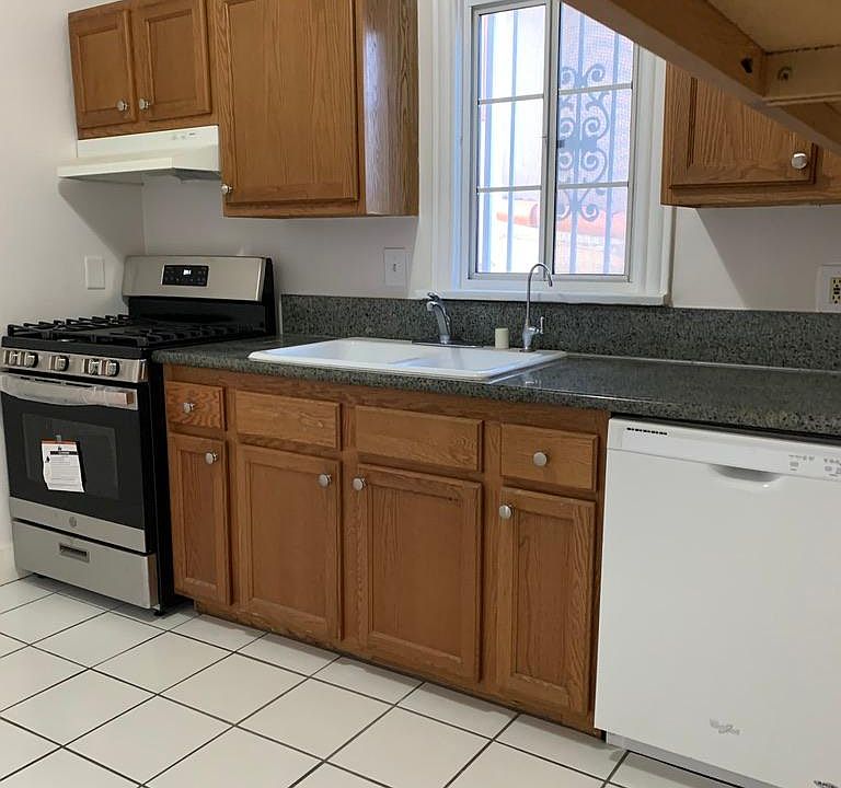 Kitchen with new gas stove and newer tile. Dishwasher and refrigerator included.