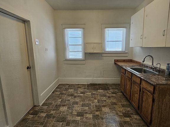 Large kitchen with cupboards and counterspace + food prep area at north end, and room for small table,
