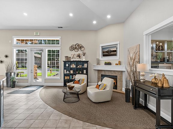 Welcoming clubhouse lounge with cozy seating and fireplace.