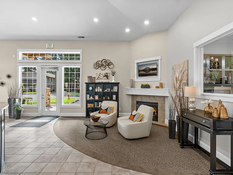 Welcoming clubhouse lounge with cozy seating and fireplace.