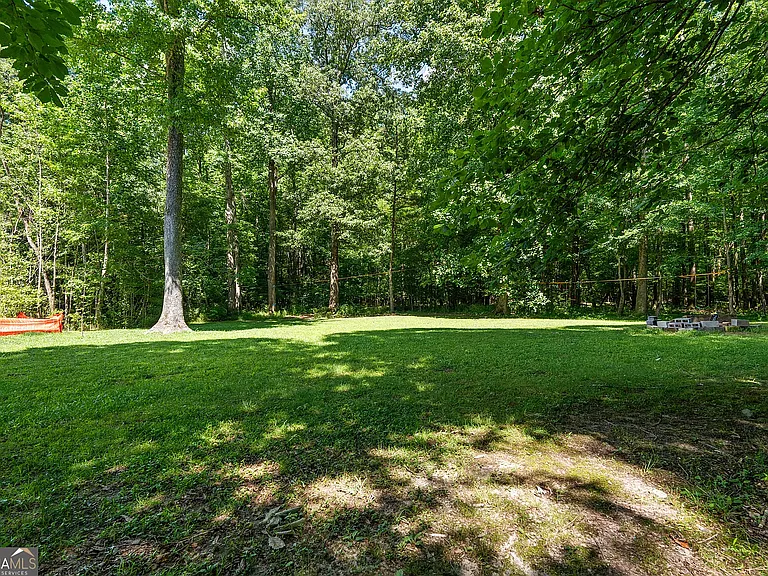 Large backyard! Firepit in rear and shed for storage. Fully fenced in (wire fencing through woods with gate access to creek at the rear, and wooden fencing up top)