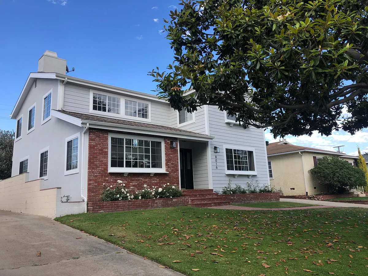 Large grass front yard with magnolia tree and white roses in planters - 8016 Dunbarton Ave