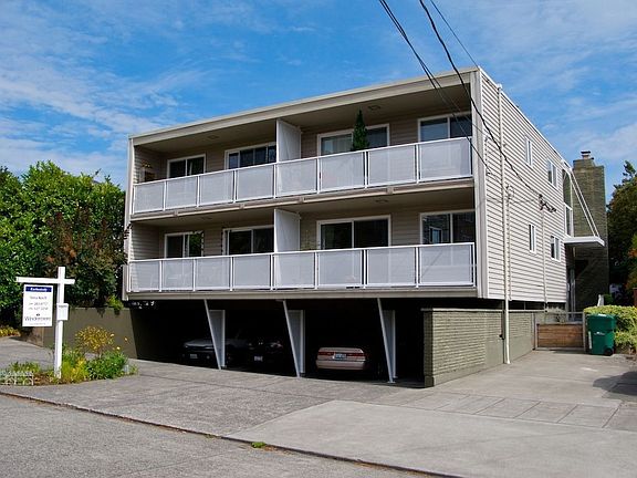 Unit 302 is the top-left unit (north side of the building).  Parking to right.