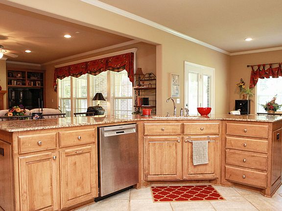 The large island can comfortably accommodate six people and opens to the living room for easy entert