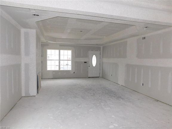 Family Room with Tray Ceiling. Recessed Lights and Ceiling Fan in center.  Fireplace to on left Wall