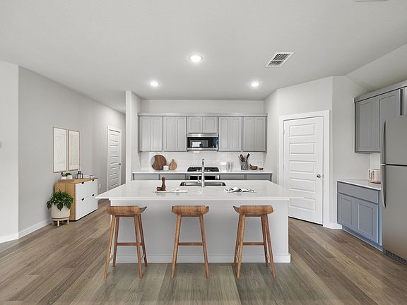 Kitchen in the Emmy II home plan by Trophy Signature Homes - REPRESENTATIVE PHOTO