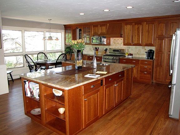 Gourmet Kitchen with Slab Granite and Cherry Cabinetry