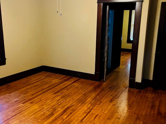 Bedroom #1. Bathroom is located through the door to the left. The second bedroom is located straight ahead. Living room and kitchen through the door to the right.