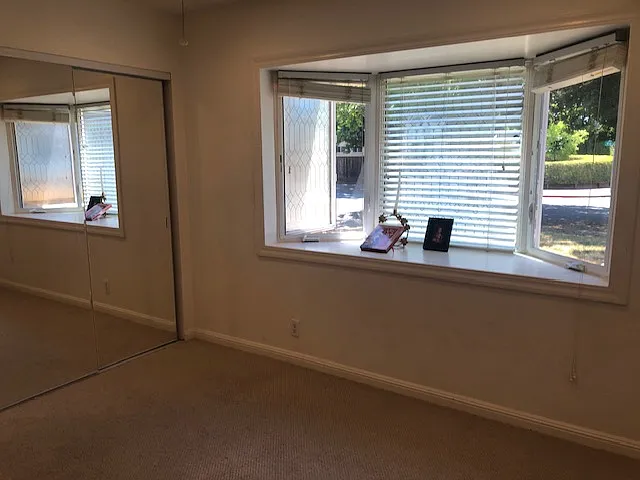 Bedroom #2: Mirror closet sliding doors, giant size bay windows, built in ceiling lights and fan combo, and new carpets and fresh wall paint