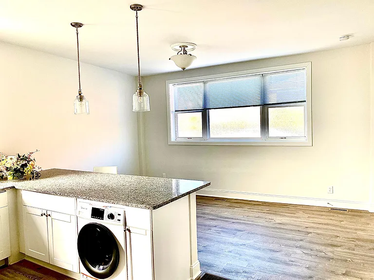 kitchen to living room with in unit washer dryer