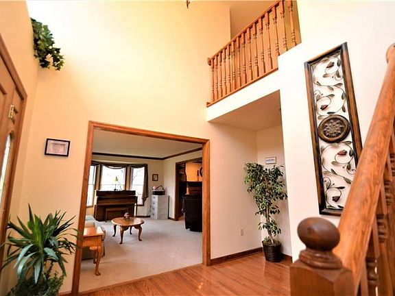 2 story entry level featuring Exquisite hardwood floor, chandelier,  and Oak staircase