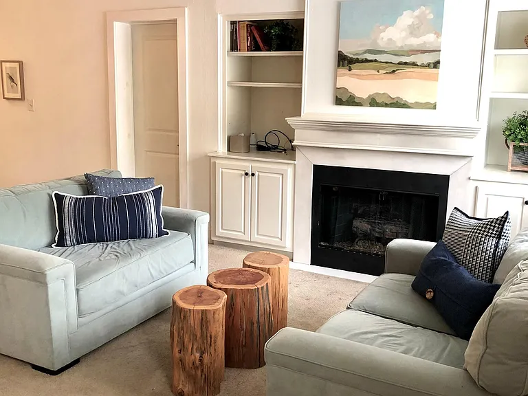 Cozy living room with fireplace and built-in bookcases.