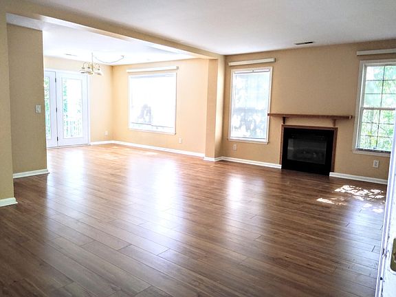 Living room and dining room which opens onto deck. Lots of big windows and great light.